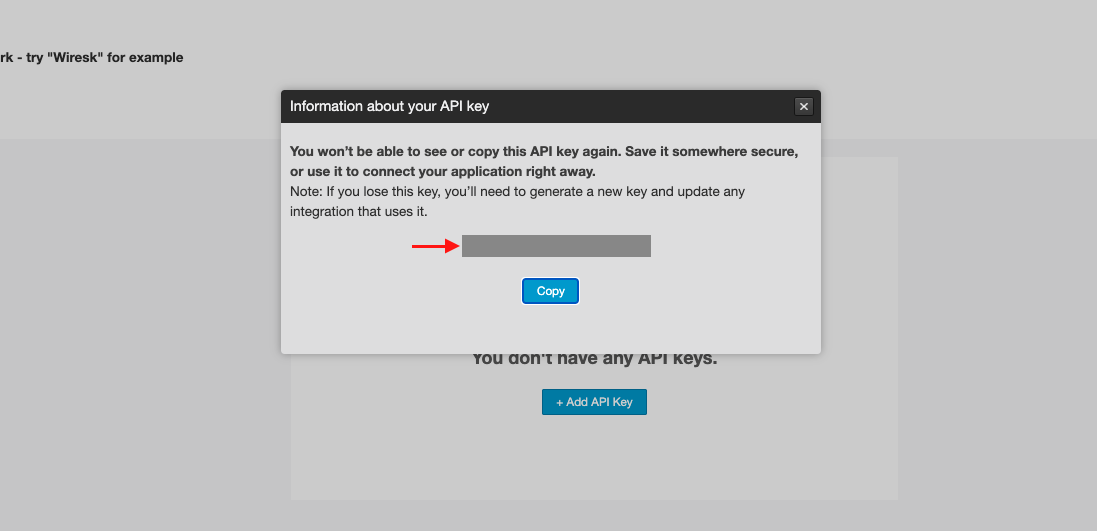 Screenshot of Mailchimp transactional API key screen. it shows a prompted screen with a hidden API key and a red arrow pointing to it, and a Copy button.