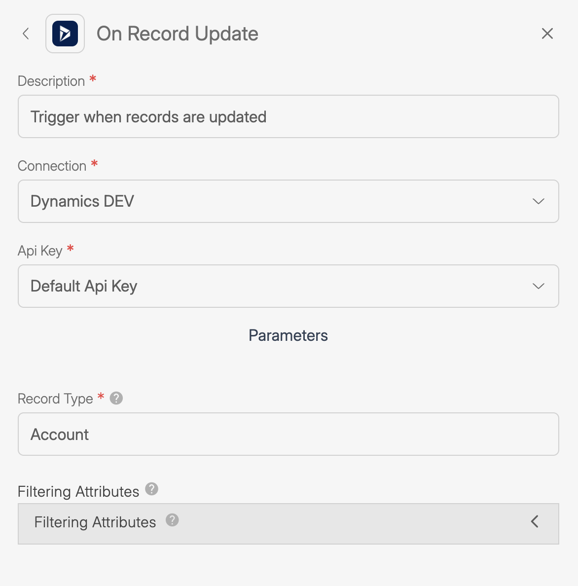 Screenshot of the “On Record Update” trigger settings in Wiresk for Dynamics CRM. The Description field says “Trigger when records are updated.” Connection is set to “Dynamics DEV,” API Key is “Default Api Key,” Record Type is “Account,” and there is a section for Filtering Attributes with a collapsed menu.